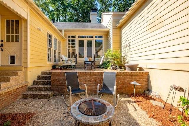 view of patio / terrace with french doors and an outdoor fire pit