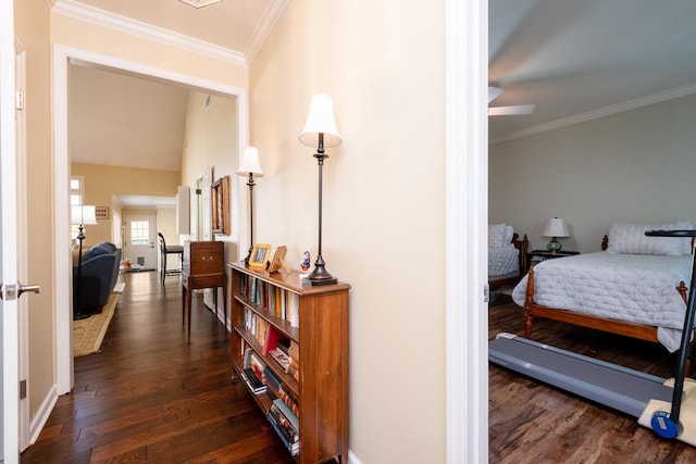 hall with dark wood-type flooring and ornamental molding