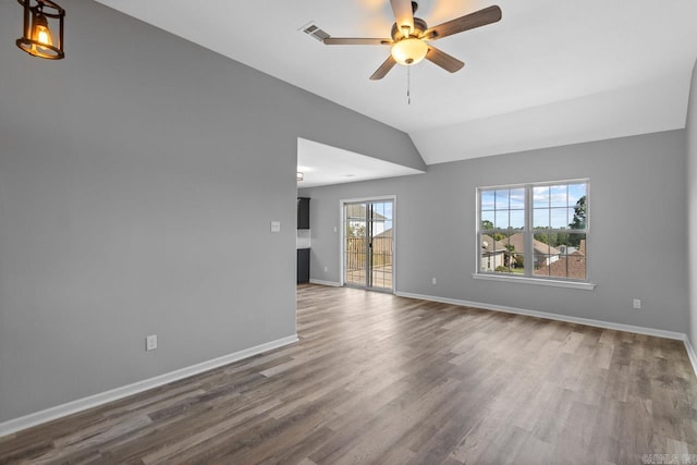 unfurnished living room featuring hardwood / wood-style flooring, ceiling fan, and vaulted ceiling