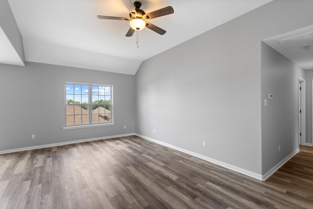 empty room with ceiling fan, lofted ceiling, and dark hardwood / wood-style floors