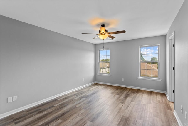 empty room featuring hardwood / wood-style flooring and ceiling fan