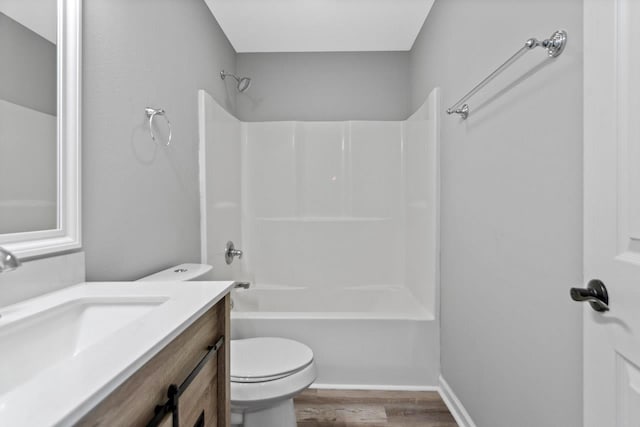 full bathroom featuring wood-type flooring, tub / shower combination, vanity, and toilet