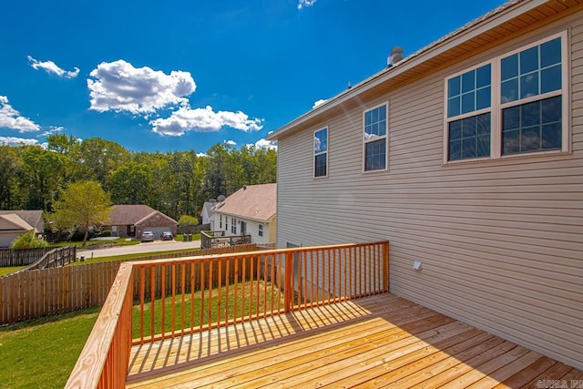 wooden terrace featuring a yard