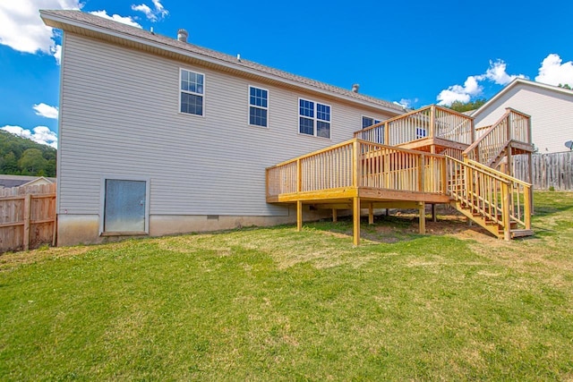 back of property featuring a yard and a deck