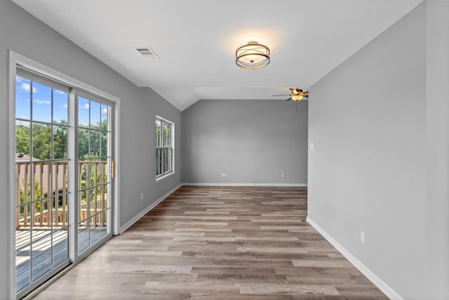 interior space with ceiling fan, lofted ceiling, and light hardwood / wood-style flooring