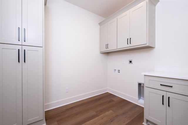 washroom with dark wood-type flooring, cabinets, hookup for an electric dryer, and hookup for a washing machine