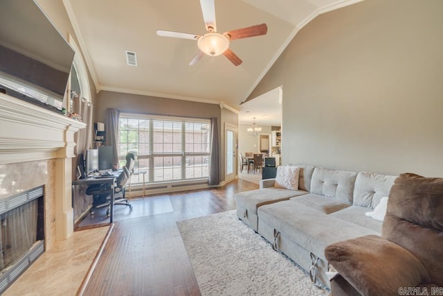 living room with crown molding, high vaulted ceiling, hardwood / wood-style floors, a premium fireplace, and ceiling fan with notable chandelier