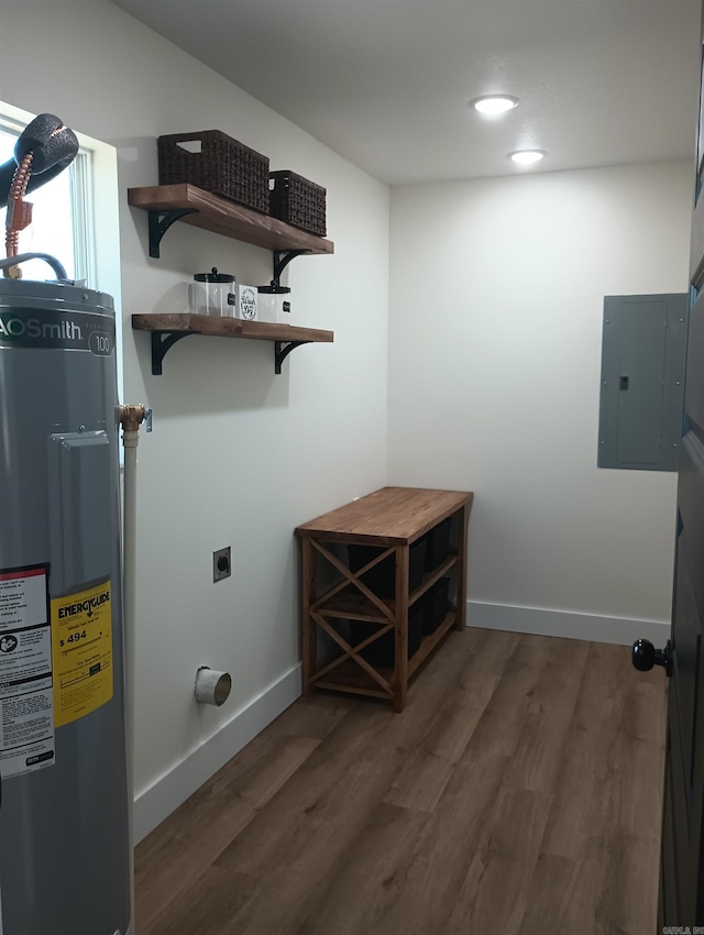 washroom featuring water heater, hookup for an electric dryer, electric panel, and dark hardwood / wood-style flooring