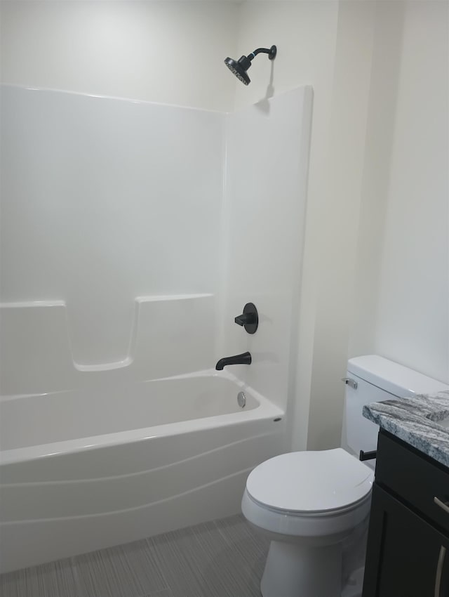 full bathroom featuring shower / washtub combination, toilet, tile patterned flooring, and vanity