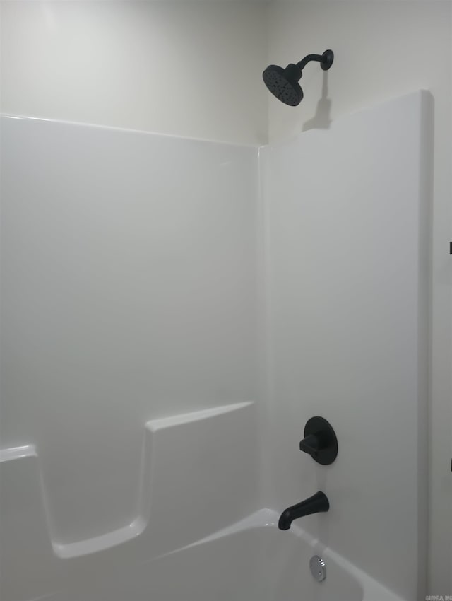 room details featuring shower / tub combination