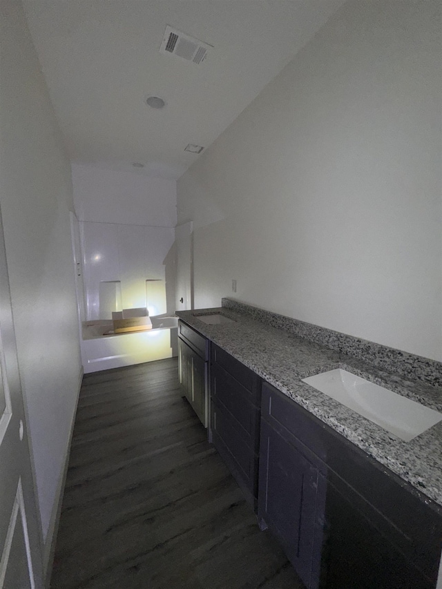 interior space featuring a sink, dark wood finished floors, and visible vents