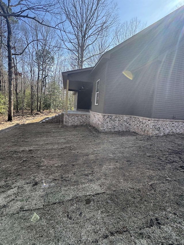 view of property exterior featuring driveway and a carport