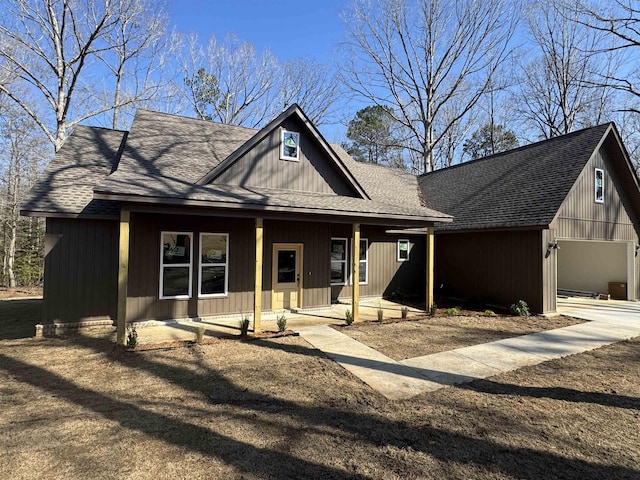 view of front facade with covered porch and roof with shingles