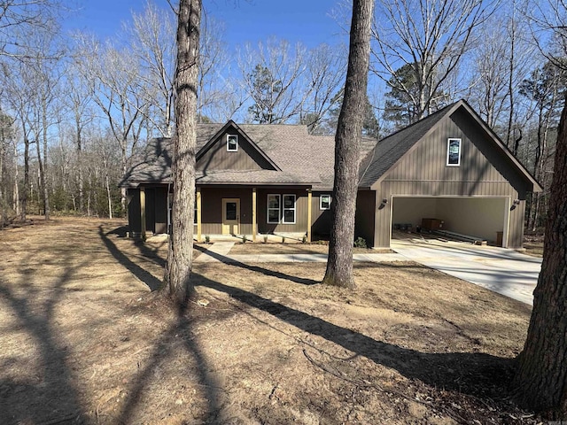 view of front facade with concrete driveway and roof with shingles