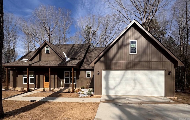 view of front of house with covered porch, driveway, and a shingled roof