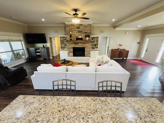 living room featuring a fireplace, ornamental molding, and dark hardwood / wood-style floors