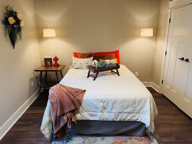 bedroom with dark wood-type flooring