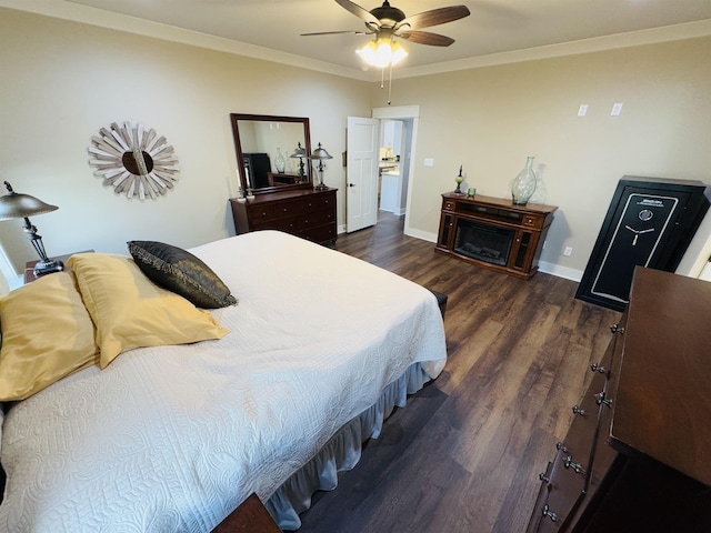 bedroom with dark hardwood / wood-style flooring, crown molding, and ceiling fan