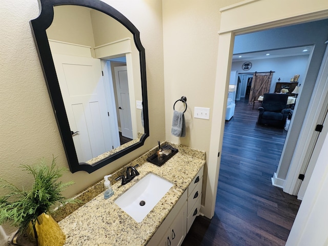 bathroom featuring hardwood / wood-style flooring and vanity