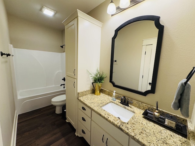 full bathroom with wood-type flooring, vanity, shower / bathtub combination, and toilet