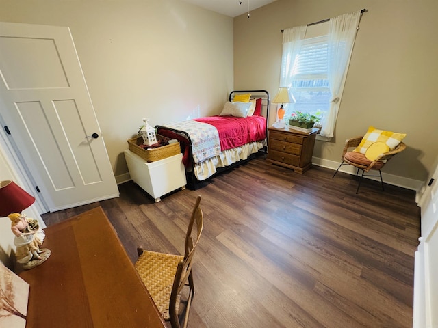 bedroom with dark hardwood / wood-style floors