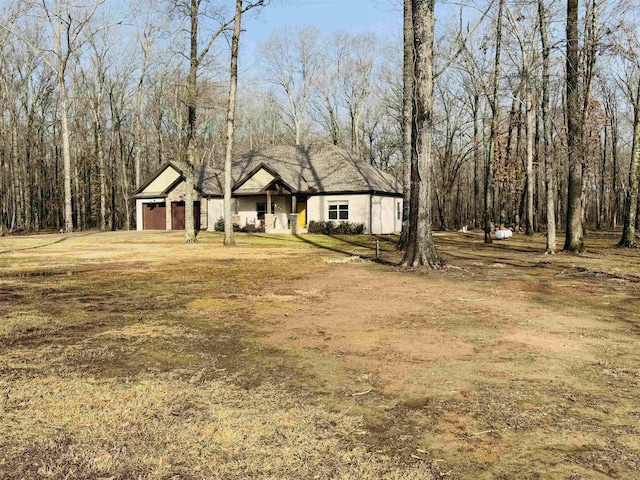 view of front of property with a garage and a front lawn