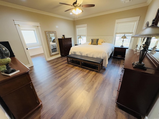 bedroom featuring ornamental molding, dark wood-type flooring, and ceiling fan