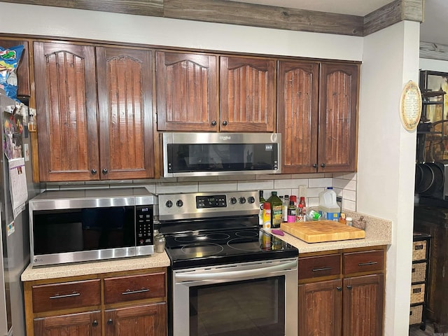 kitchen featuring appliances with stainless steel finishes and decorative backsplash