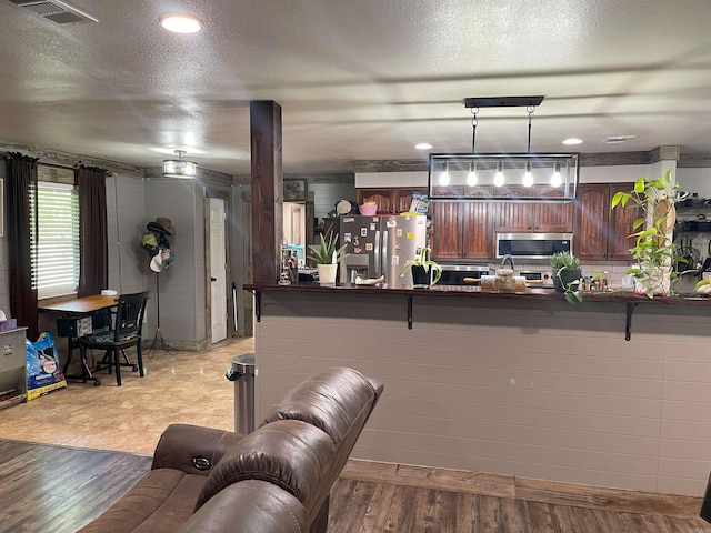 living room featuring a textured ceiling and light wood-type flooring