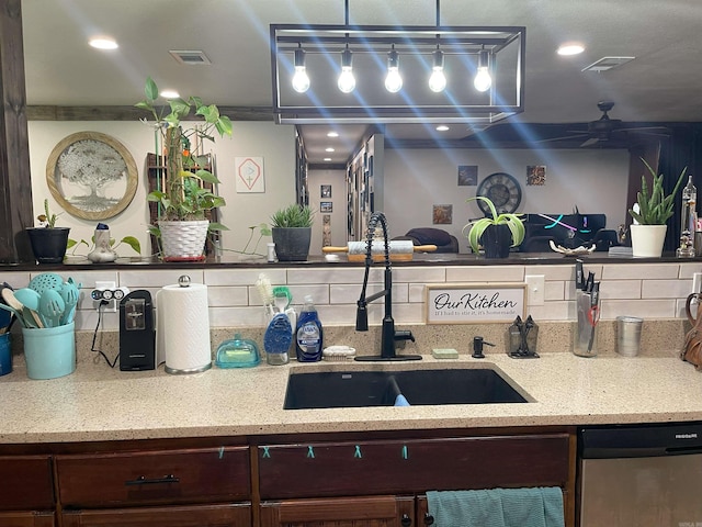 kitchen with ceiling fan, stainless steel dishwasher, dark brown cabinetry, and sink