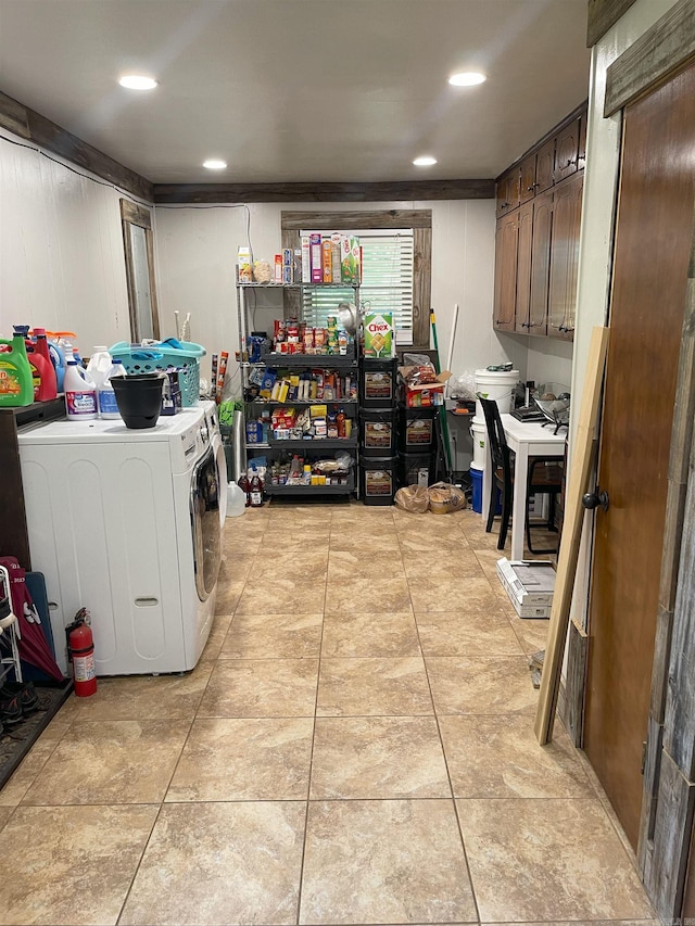 clothes washing area with light tile patterned floors and washing machine and clothes dryer