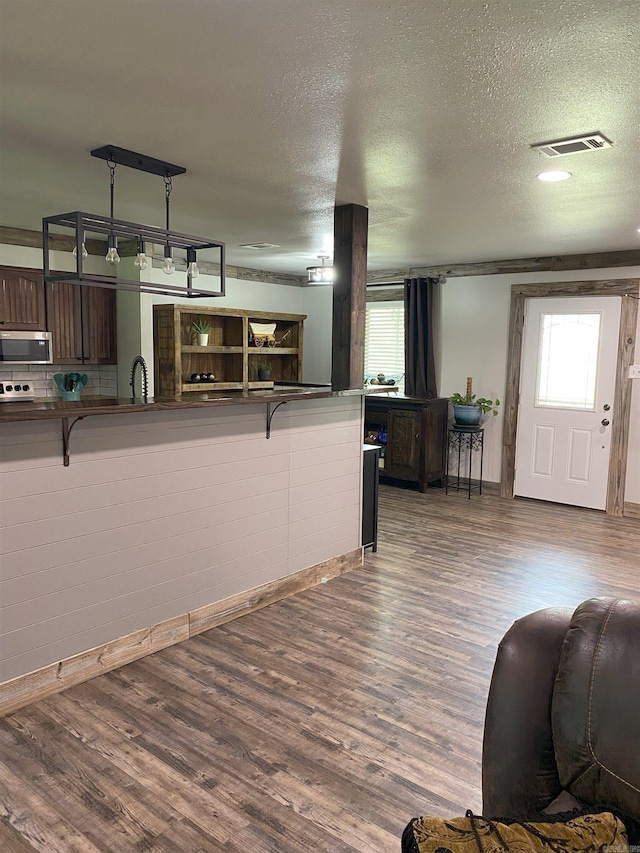 149 Roden Mill Rd, Conway, AR 72032 - living room featuring a textured ceiling, healthy amount of natural light, wood finished floors, and baseboards