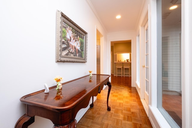 hallway featuring light parquet flooring and ornamental molding