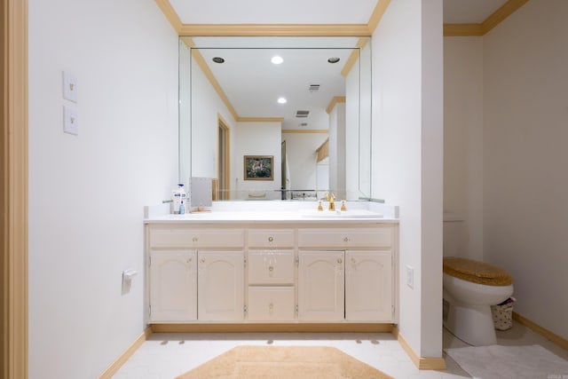 bathroom featuring crown molding, vanity, and toilet