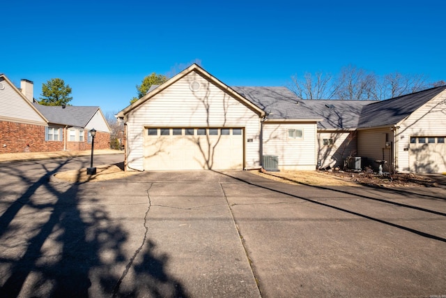 view of front facade with cooling unit and a garage