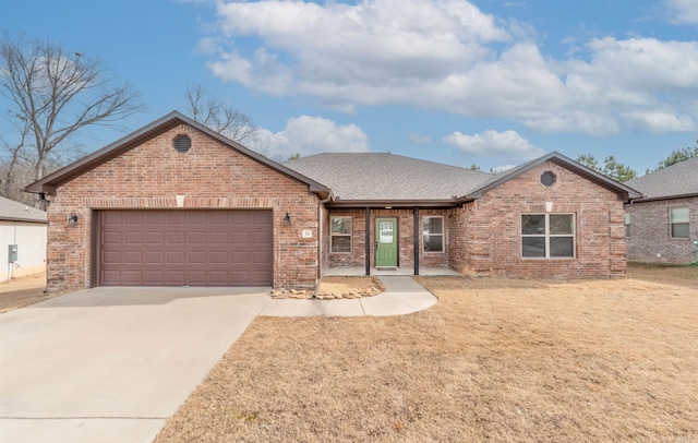 ranch-style home with a garage and a front yard