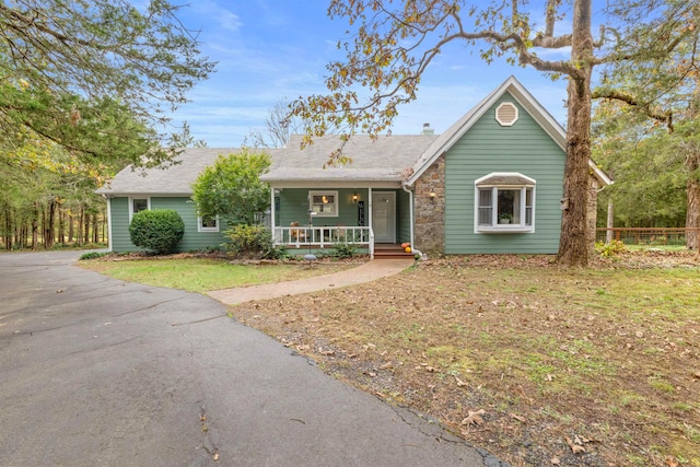 single story home with covered porch and a front lawn