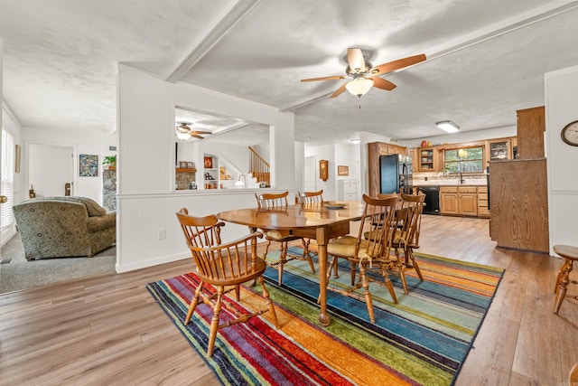 dining room with sink, light hardwood / wood-style flooring, and ceiling fan