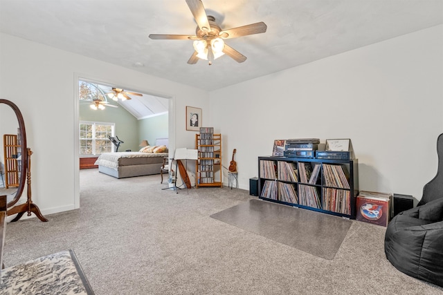 living room featuring vaulted ceiling, carpet flooring, and ceiling fan