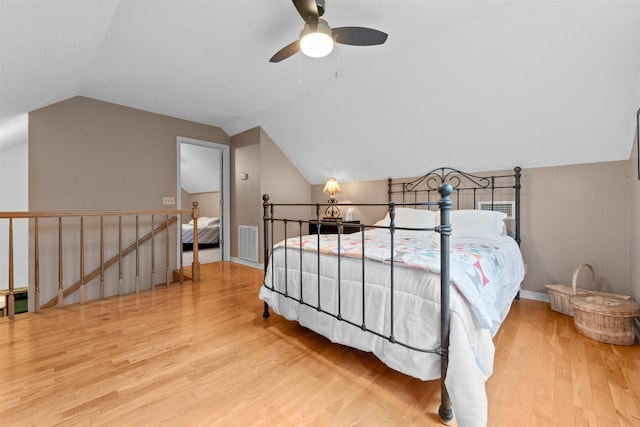 bedroom featuring ceiling fan, lofted ceiling, and wood-type flooring