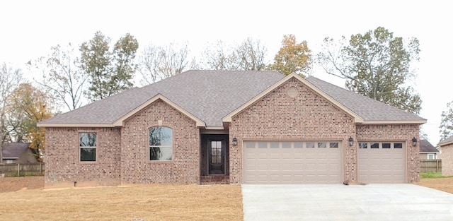 view of front of home with a garage and a front lawn