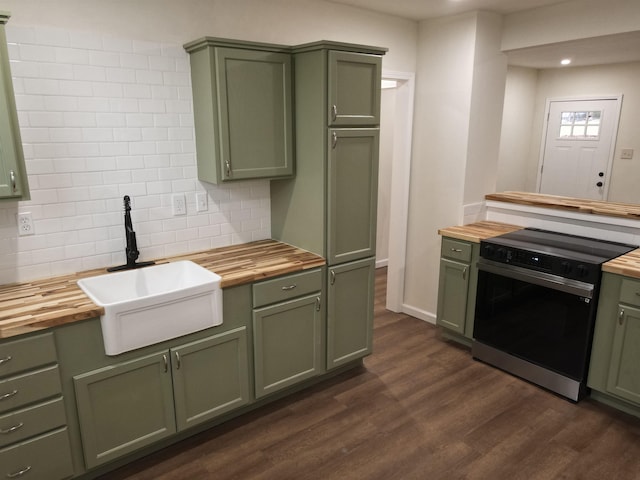 kitchen featuring electric range, butcher block countertops, and green cabinetry