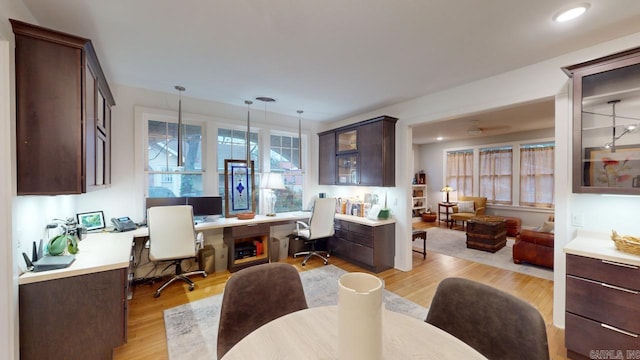 dining area featuring built in desk and light hardwood / wood-style flooring