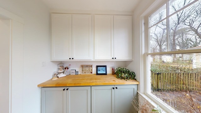 interior space featuring wood counters and white cabinets