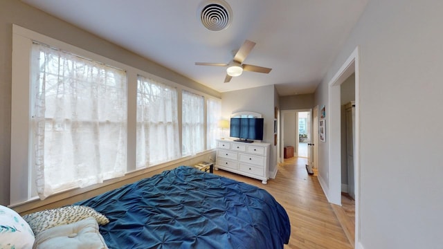 bedroom with ceiling fan and light hardwood / wood-style flooring