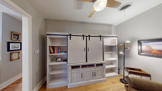 interior space featuring light wood-type flooring and ceiling fan