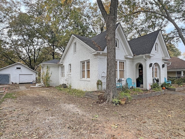 view of front of house with a garage and an outdoor structure