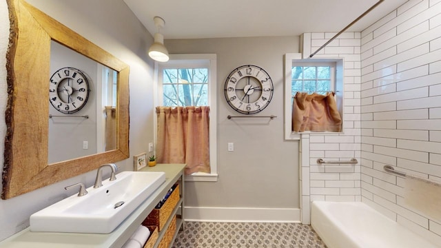 bathroom featuring tiled shower / bath, tile patterned floors, and sink