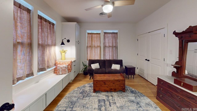 living area featuring ceiling fan and light hardwood / wood-style flooring