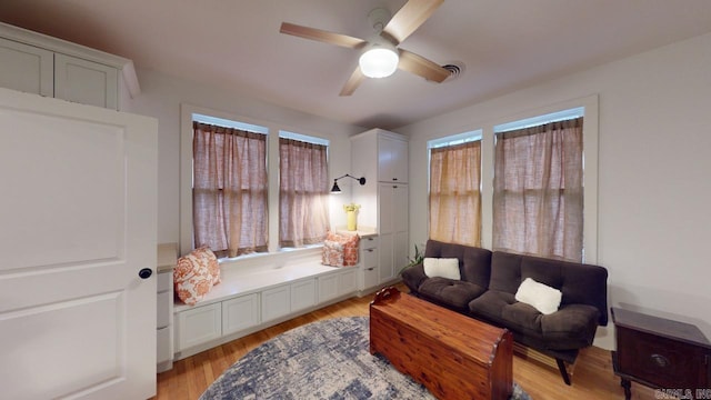 living area featuring ceiling fan and light hardwood / wood-style flooring